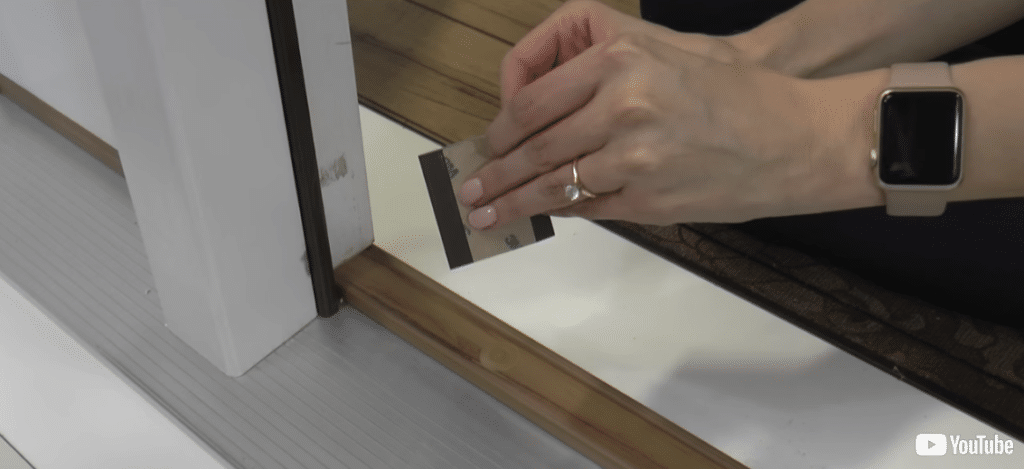 Removing the backing from a corner pad.